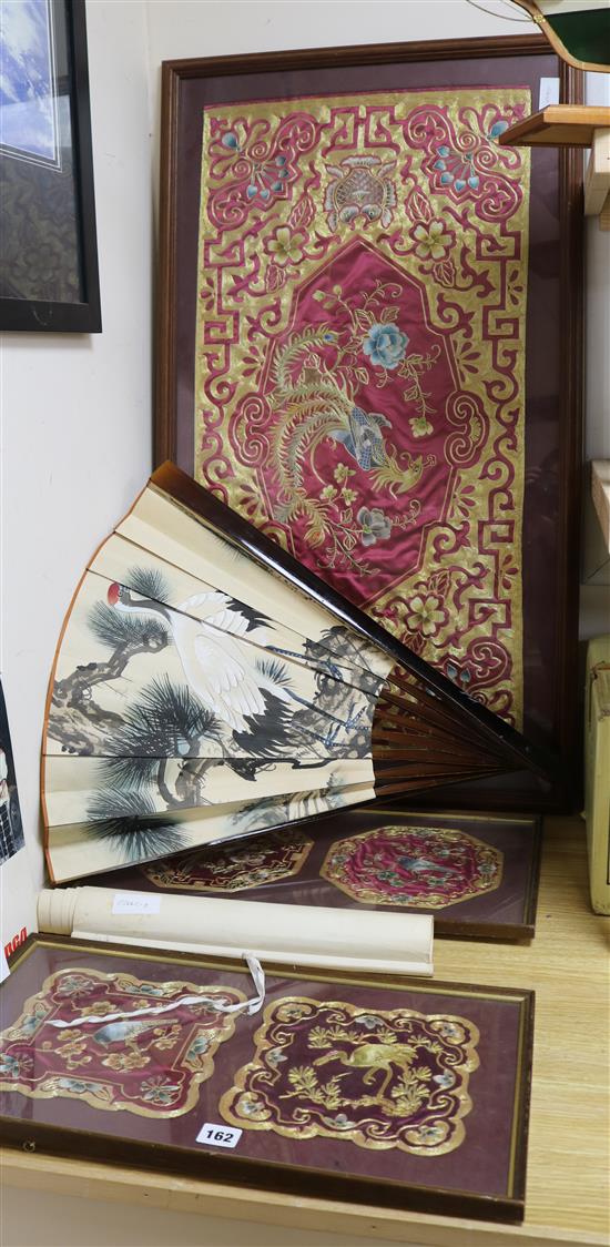 Three framed Chinese embroidered panels, a fan and a scroll